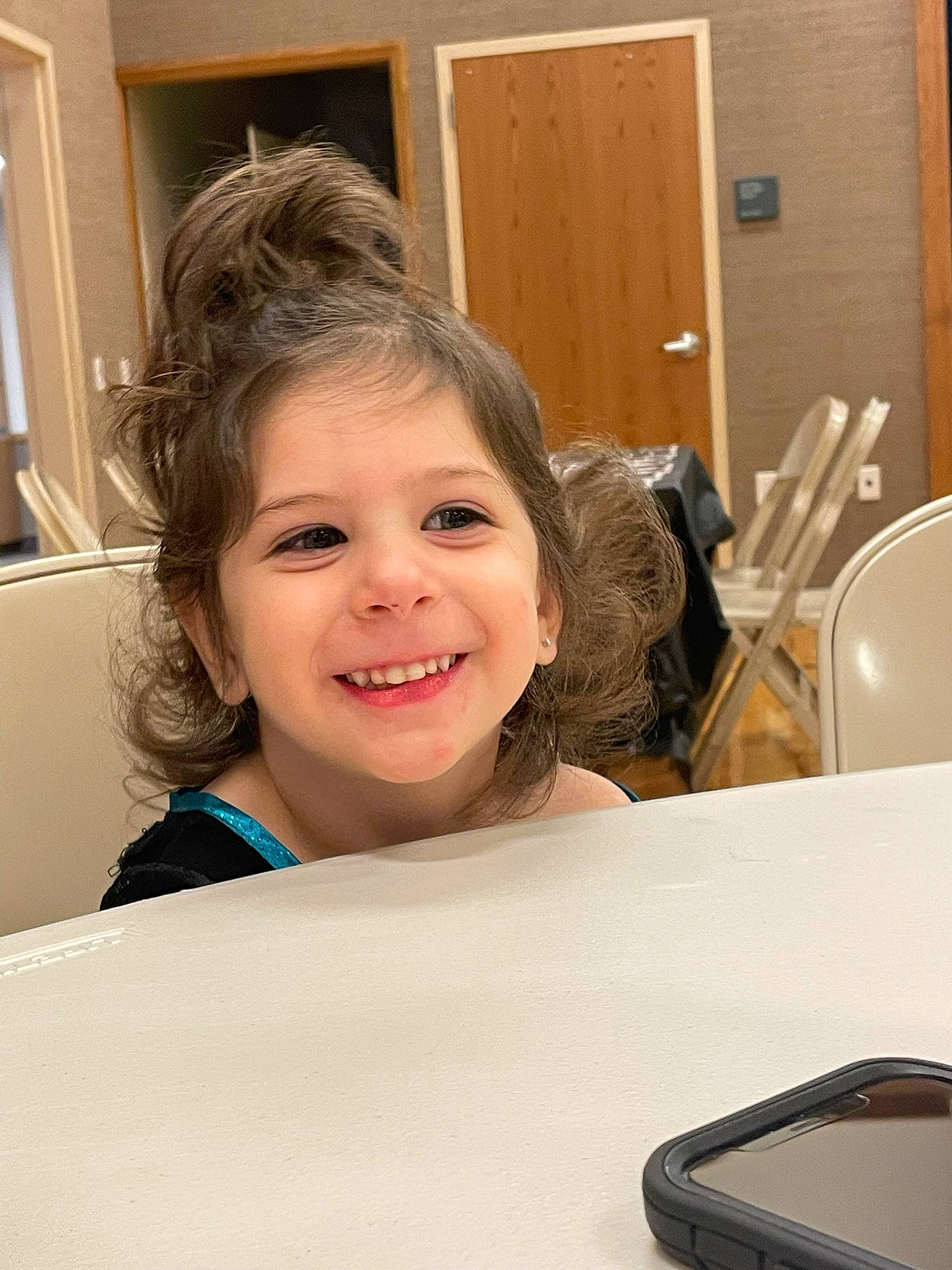 Aryah is registered to the contest to win money with this photo: audio_equipment, blond, chair, cheek, child, communication_device, door, eyelash, fun, hairstyle, happy, joy, kitchen_utensil, laugh, person, plate, room, sitting, smile, t_shirt