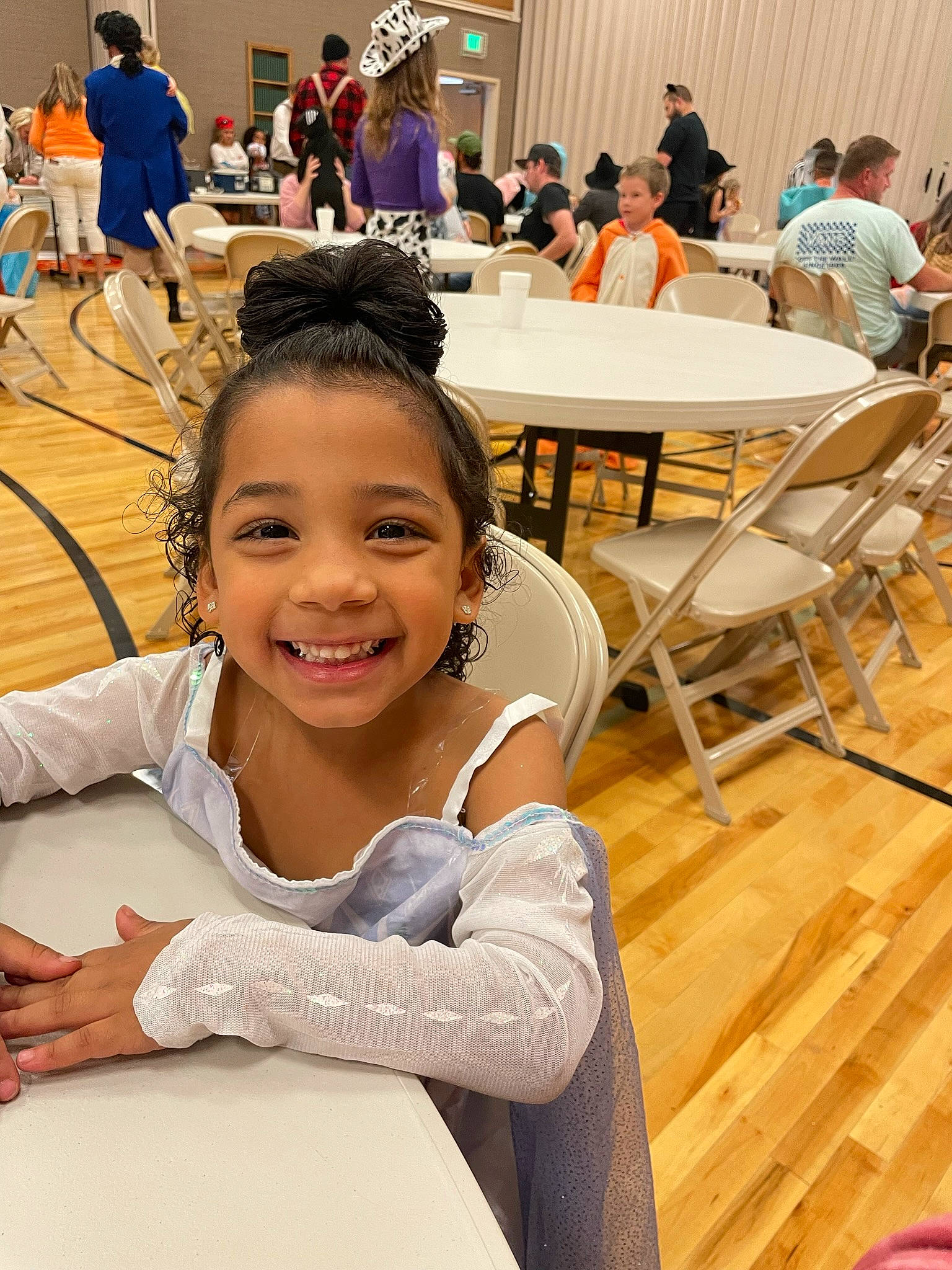 Realynn joined the competition — help win amazing prizes! chair, child, elbow, event, flooring, fun, happy, human_leg, joy, leisure, person, recreation, room, sitting, skin, smile, summer, t_shirt, table, thigh