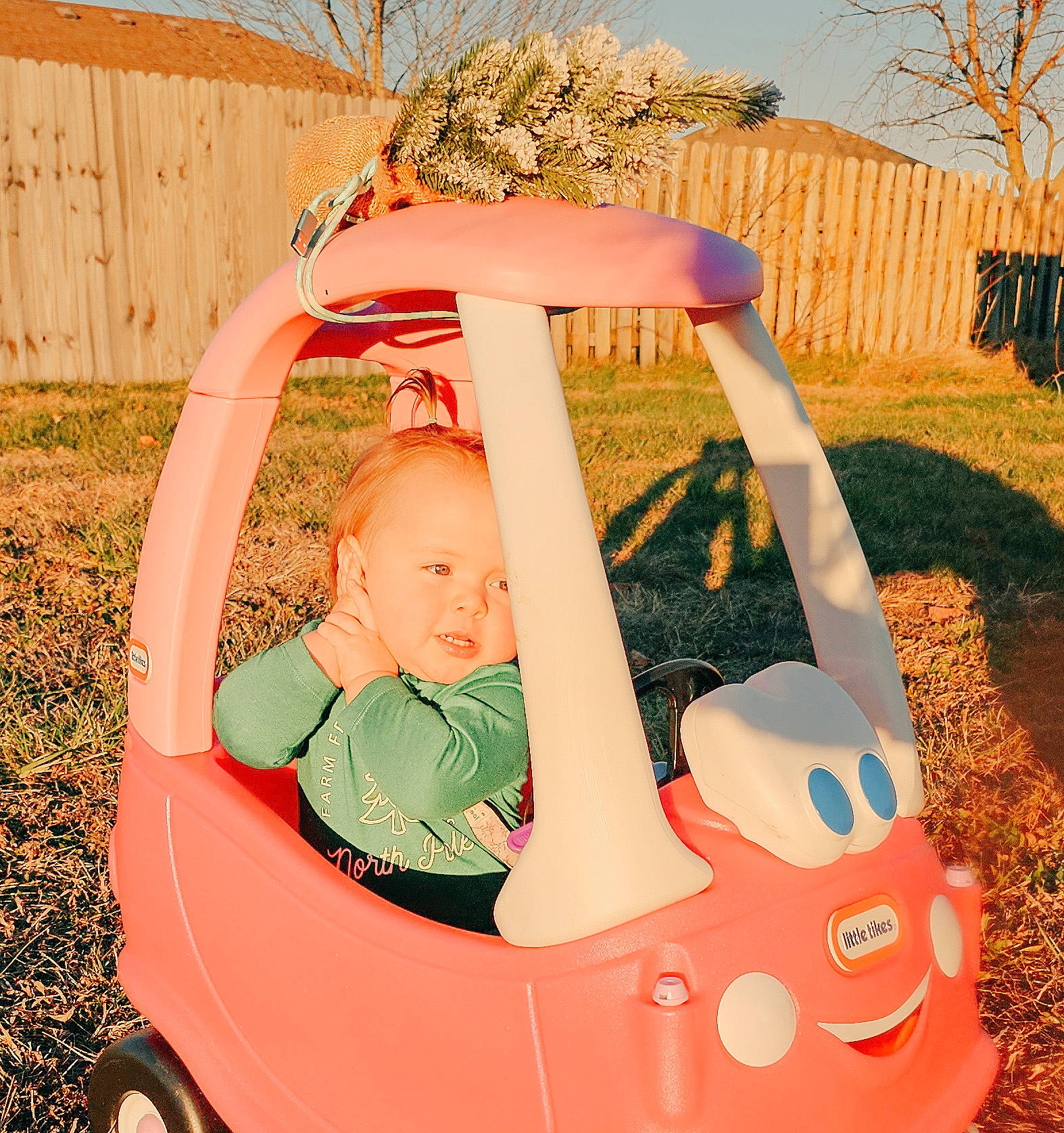 Harper Lakey is registered to the contest to win money with this photo: arm, baby, baby_products, baby_toddler_clothing, fun, grass, happy, leisure, motor_vehicle, people_in_nature, person, plant, play, recreation, sitting, tire, toddler, tree, vehicle, wheel