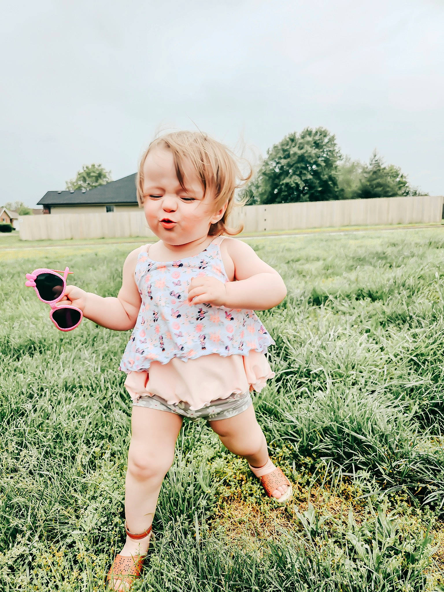 Harper Lakey is registered to the contest to win money with this photo: baby_toddler_clothing, blond, child, flash_photography, fun, gesture, grass, grass_family, grassland, happy, lawn, meadow, people_in_nature, person, plant, playing_with_kids, sky, summer, sunlight, toddler