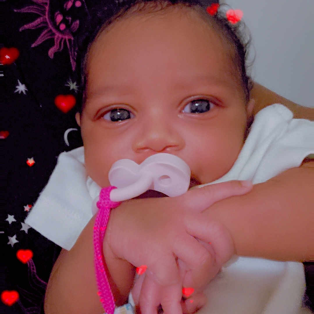 Tamiracle joined the competition — help win amazing prizes! adorable, baby, background, child, closeup, comfort, cute, expression, face, hand, heart, indoors, infant, love, newborn, pacifier, person, skin, sleepwear, soft