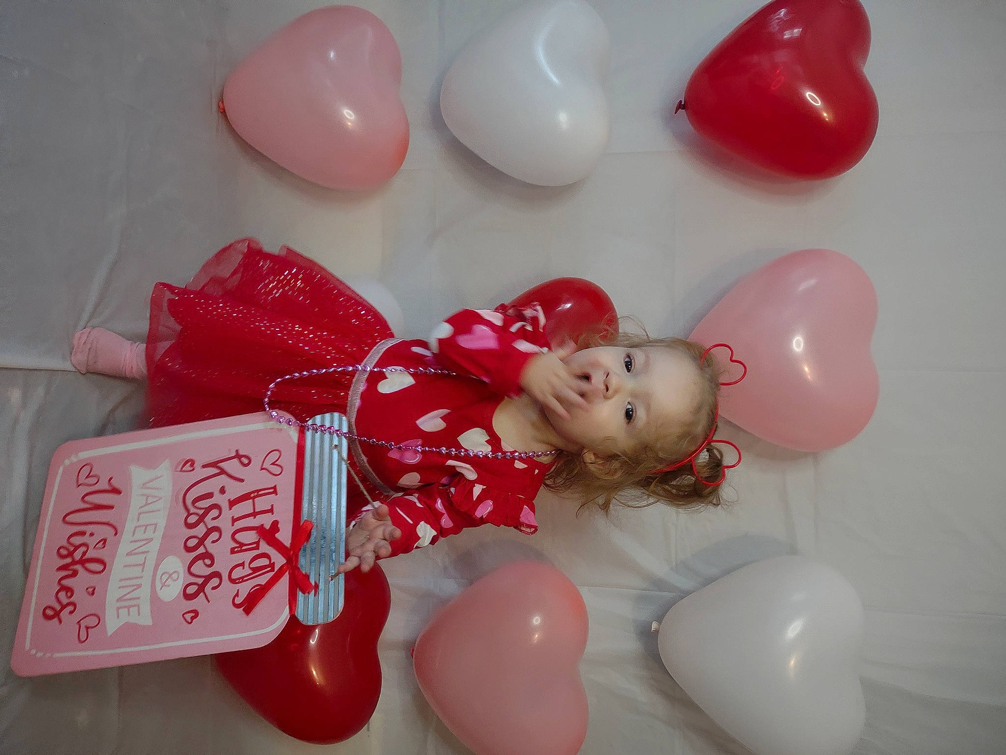 Jocelyn is registered to the contest to win money with this photo: balloon, carmine, event, fun, happy, magenta, material_property, party_supply, person, pink, plastic, plastic_arts, red, souvenir, sweetness, toy, white
