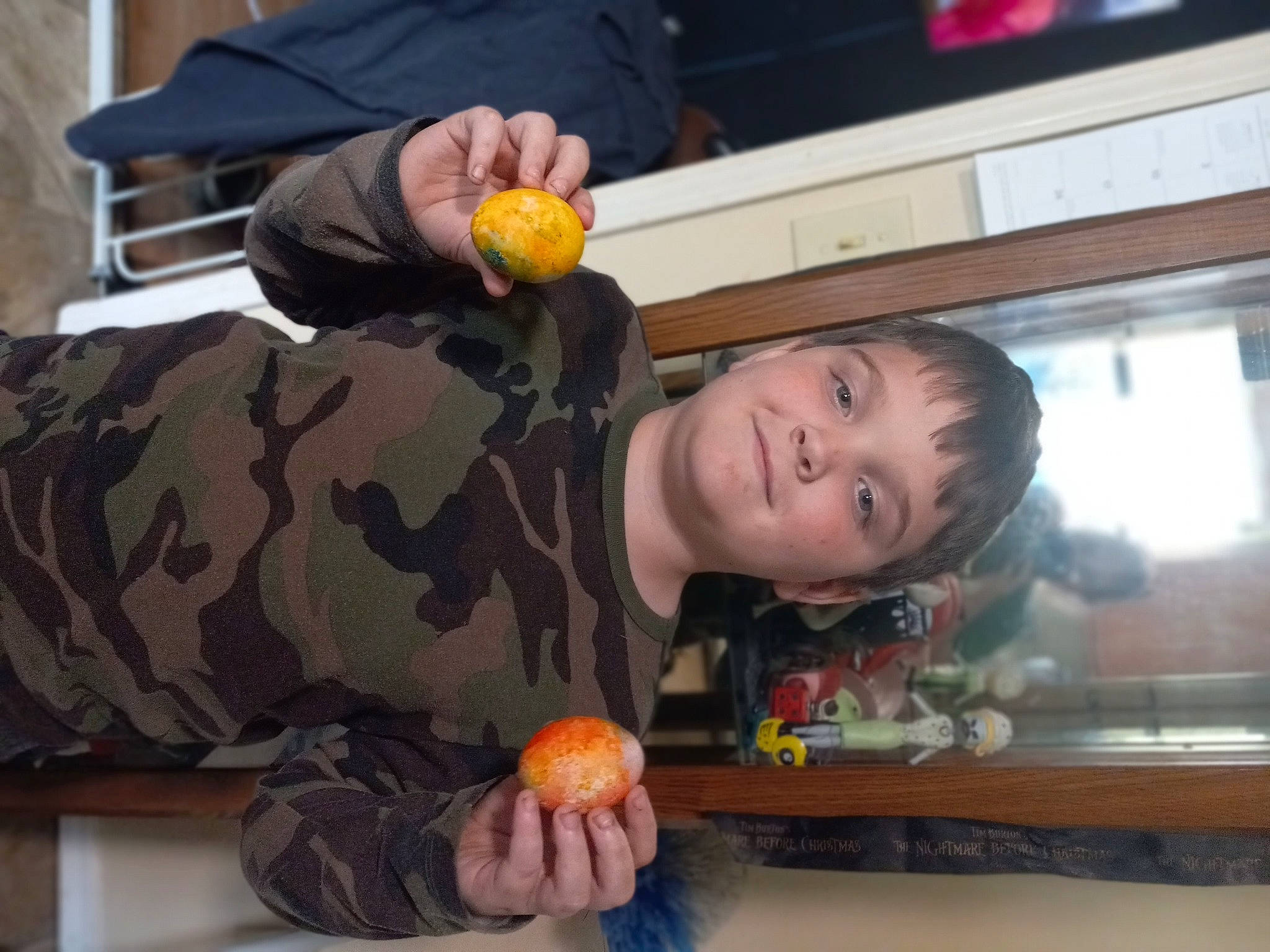 Aaron is registered to the contest to win money with this photo: army, camouflage, child, food, fruit, fun, happy, joy, military_camouflage, military_organization, military_person, military_uniform, natural_foods, non_commissioned_officer, orange, person, plant, room, smile, soldier