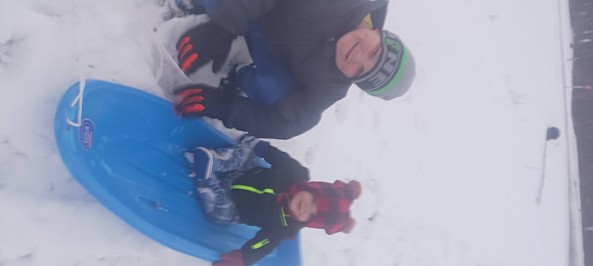 Aaron is registered to the contest to win money with this photo: adventure, blurred, carmine, child, electric_blue, extreme_sport, freezing, fun, happy, headwear, ice_cap, joy, leisure, person, personal_protective_equipment, playing_in_the_snow, recreation, slope, snow, toddler