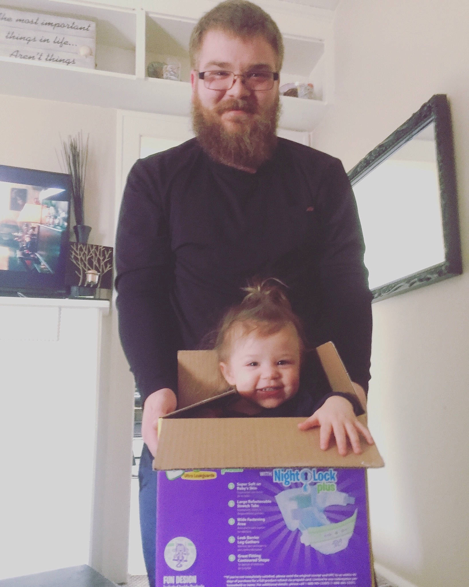 Alaina is registered to the contest to win money with this photo: baby, beard, child, electronic_device, face, facial_hair, family, hair, hairstyle, head, moustache, person, shoulder, smile, t_shirt, toddler, tooth, vacation