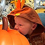 Alexander is registered to the contest to win money with this photo: baby, infant, hoodie, pumpkin, orange, leaf, cute, child, face, portrait, cozy, soft_lighting, buttoned_clothing, indoor, closeup, curious, fall_theme, seasonal, warm_colors, person