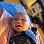 baby, infant, towel, clothing, star_wars, chewbacca, darth_vader, face, expression, happy, indoors, blurred_background, soft_lighting, portrait, cute, person, newborn, smiling, sleepwear, cozy