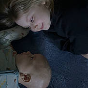 Alexander is registered to the contest to win money with this photo: child, baby, toddler, sibling_relationship, lying_down, carpet, blanket, pajamas, face, profile, gaze, soft_lighting, cozy, indoor, floor, playful, cute, bonding, portrait, hair