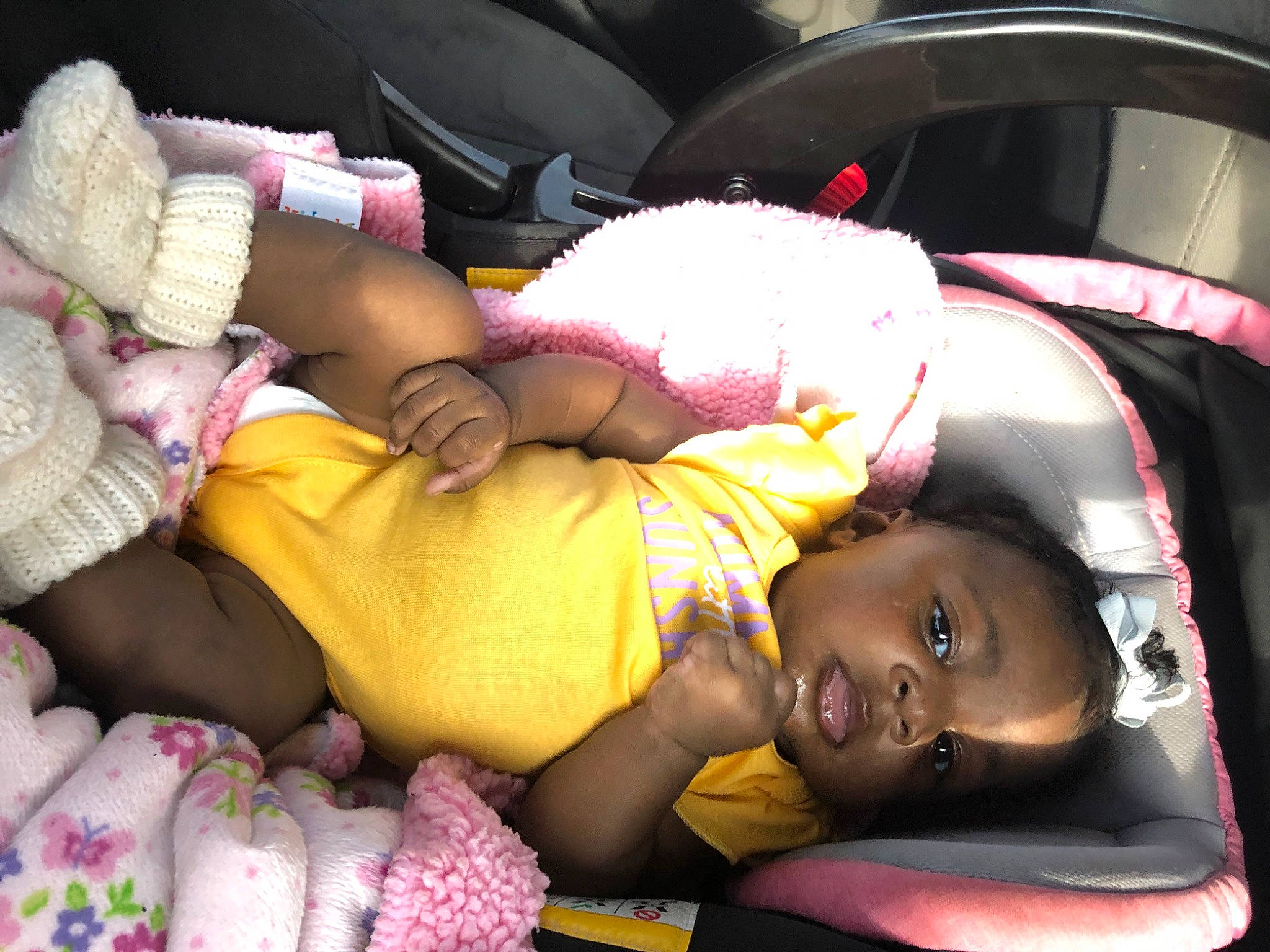 Amiricle is registered to the contest to win money with this photo: baby, beauty, black, car_seat, car_seat_cover, child, comfort, human_body, human_leg, lap, leg, linens, motor_vehicle, people, person, pink, product, textile, thigh, toddler