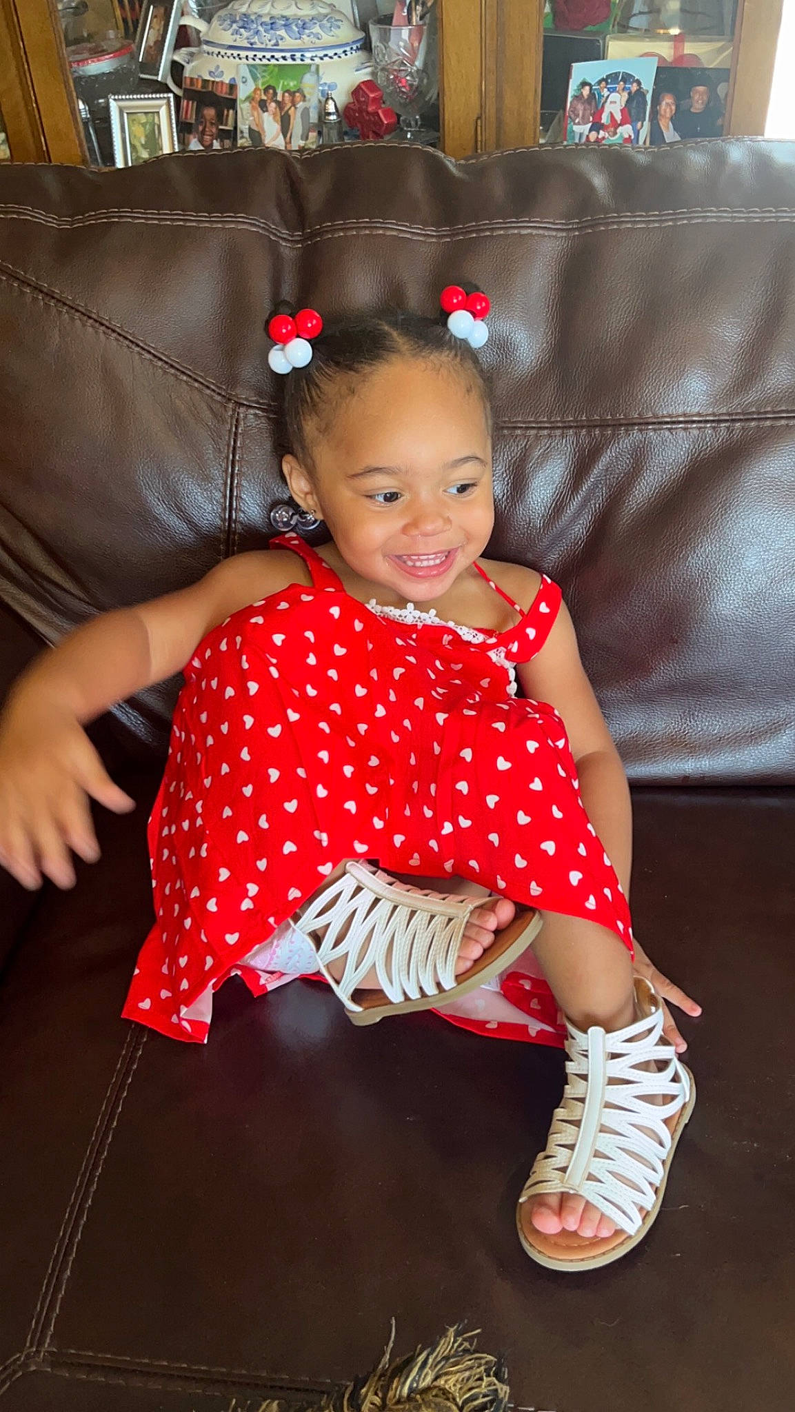 Kay Leonna is registered to the contest to win money with this photo: baby_toddler_clothing, child, couch, day_dress, dress, entertainment, fashion_design, flooring, fun, happy, human_body, human_leg, joy, magenta, pattern, person, pink, sleeve, smile, textile