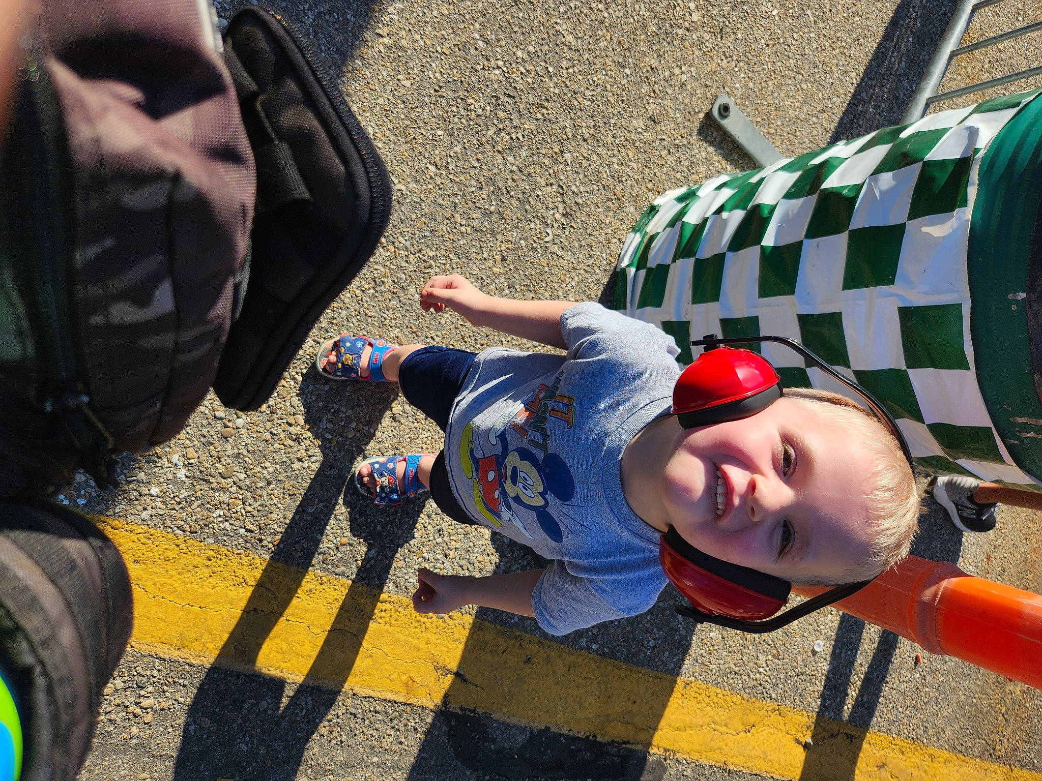 Colt is registered to the contest to win money with this photo: automotive_tire, backpack, bag, electric_blue, eyewear, fun, grass, leisure, luggage_and_bags, mammal, people, person, personal_protective_equipment, photograph, product, smile, snapshot, sports_gear, sunglasses, tire