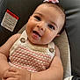 Rosalynn is registered to the contest to win money with this photo: baby, infant, smile, tongue, knitted_clothing, pink, cream, baby_seat, cushion, face, hand, cute, happy, child, portrait, head, button, hair_accessory, skin, closeup