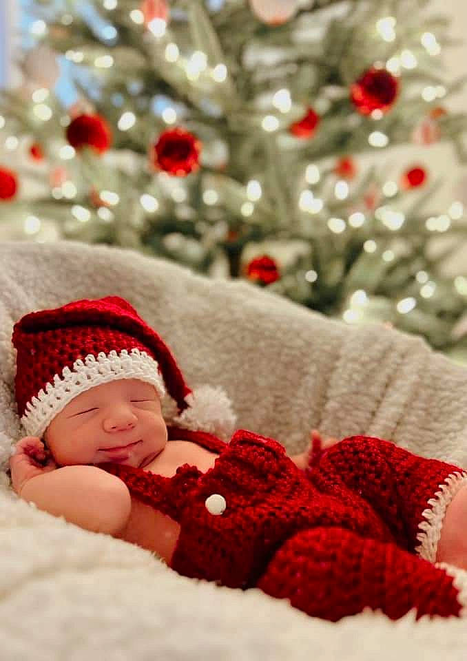 Baylor joined the competition — help win amazing prizes! baby, baby_sleeping, baby_toddler_clothing, christmas_decoration, christmas_ornament, christmas_tree, comfort, event, happy, headgear, headwear, leaf, linens, ornament, pattern, person, photograph, red, textile, toddler