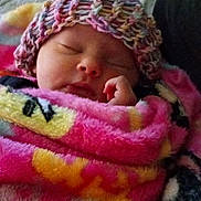 Hope is registered to the contest to win money with this photo: baby, newborn, infant, sleeping, blanket, knit_hat, hat, cozy, cute, closed_eyes, hand, portrait, indoors, bed, quilt, warm, soft_texture, pink, sleepy, adorable