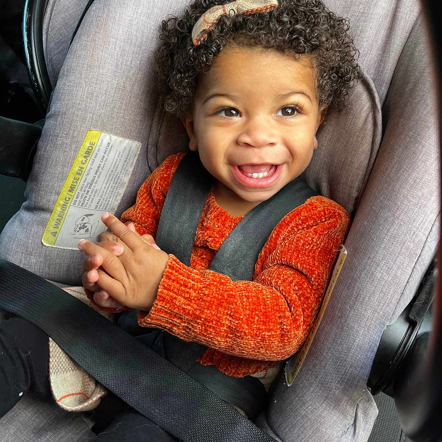 Berlin is registered to the contest to win money with this photo: accessories, belt, bodypart, car, car_interior, carseat, child, face, female, finger, girl, hand, happy, head, person, photography, portrait, smile, text, transportation