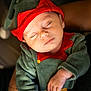 Marceau participe au concours pour gagner de l'argent avec cette photo : baby, sleeping, infant, elf_costume, red_hat, green_outfit, hand, closed_eyes, cute, holiday, festive, costume, portrait, child, soft_lighting, close_up, peaceful, newborn, cuddling, warm