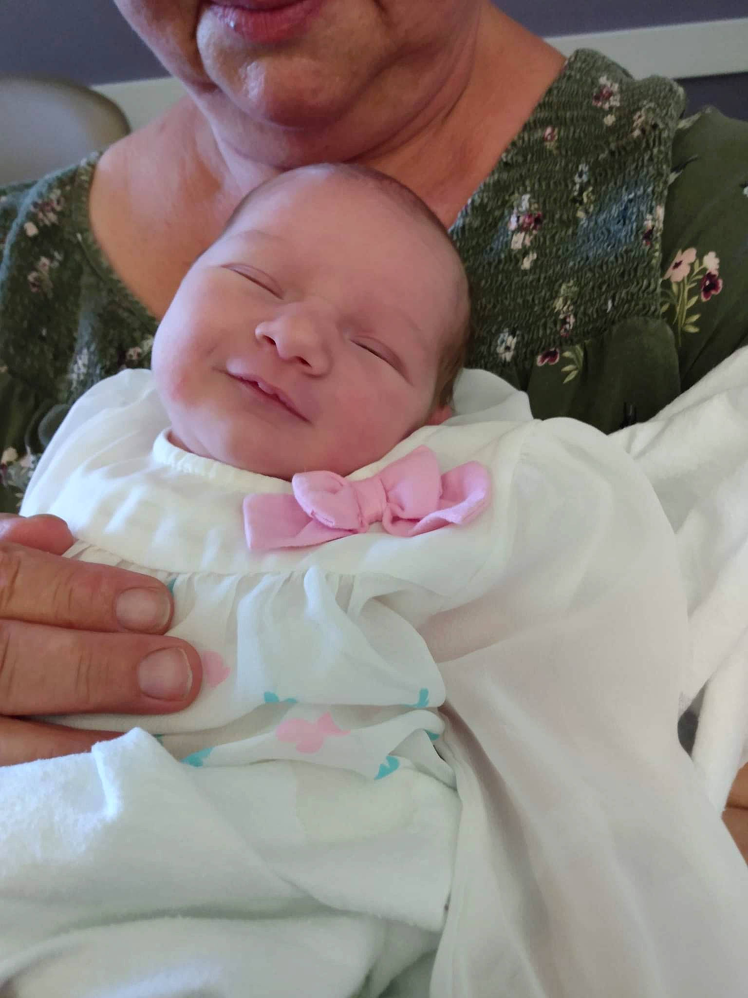 Angel Lynn is registered to the contest to win money with this photo: abdomen, baby, baby_toddler_clothing, cheek, child, chin, comfort, event, face, finger, gesture, hand, happy, linens, person, pink, sitting, skin, sleeve, thumb