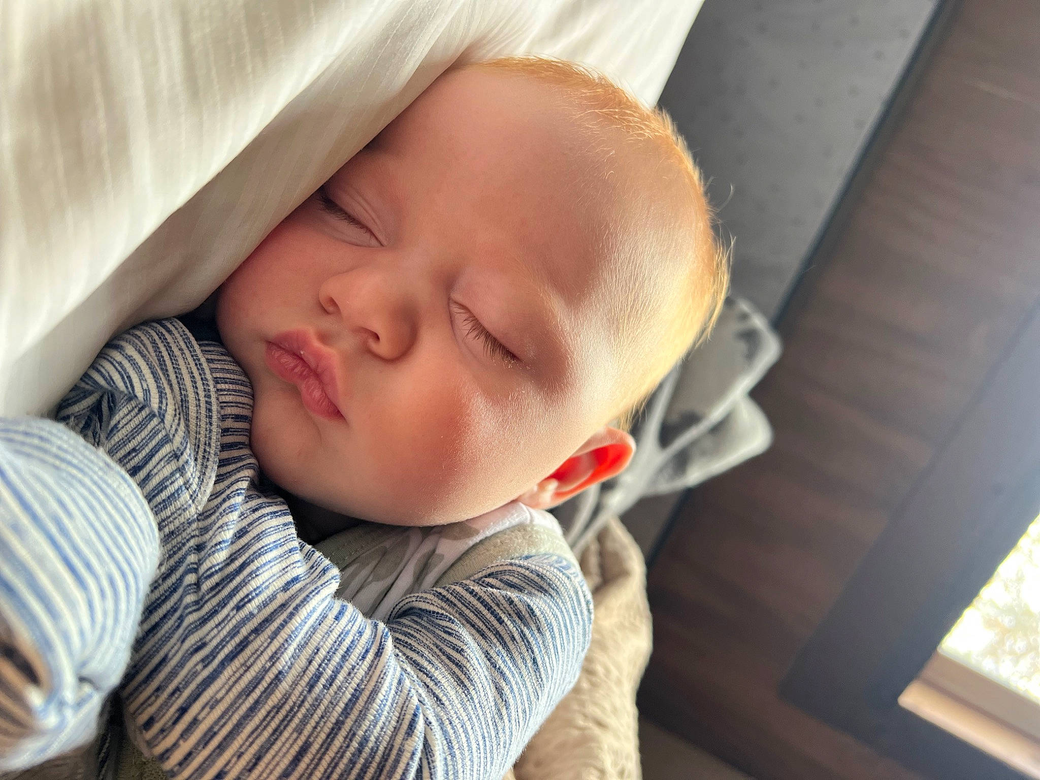 Gabriel is registered to the contest to win money with this photo: baby, baby_sleeping, baby_toddler_clothing, bedtime, cheek, child, comfort, eye, eyebrow, happy, head, linens, nap, nose, person, skin, sleeve, smile, toddler, window