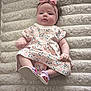 baby, bow, carpet, child, cute, face, floral_dress, footwear, hand, headband, indoor, infant, legs, pastel_colors, pink, plush, portrait, sandals, sitting, soft_texture