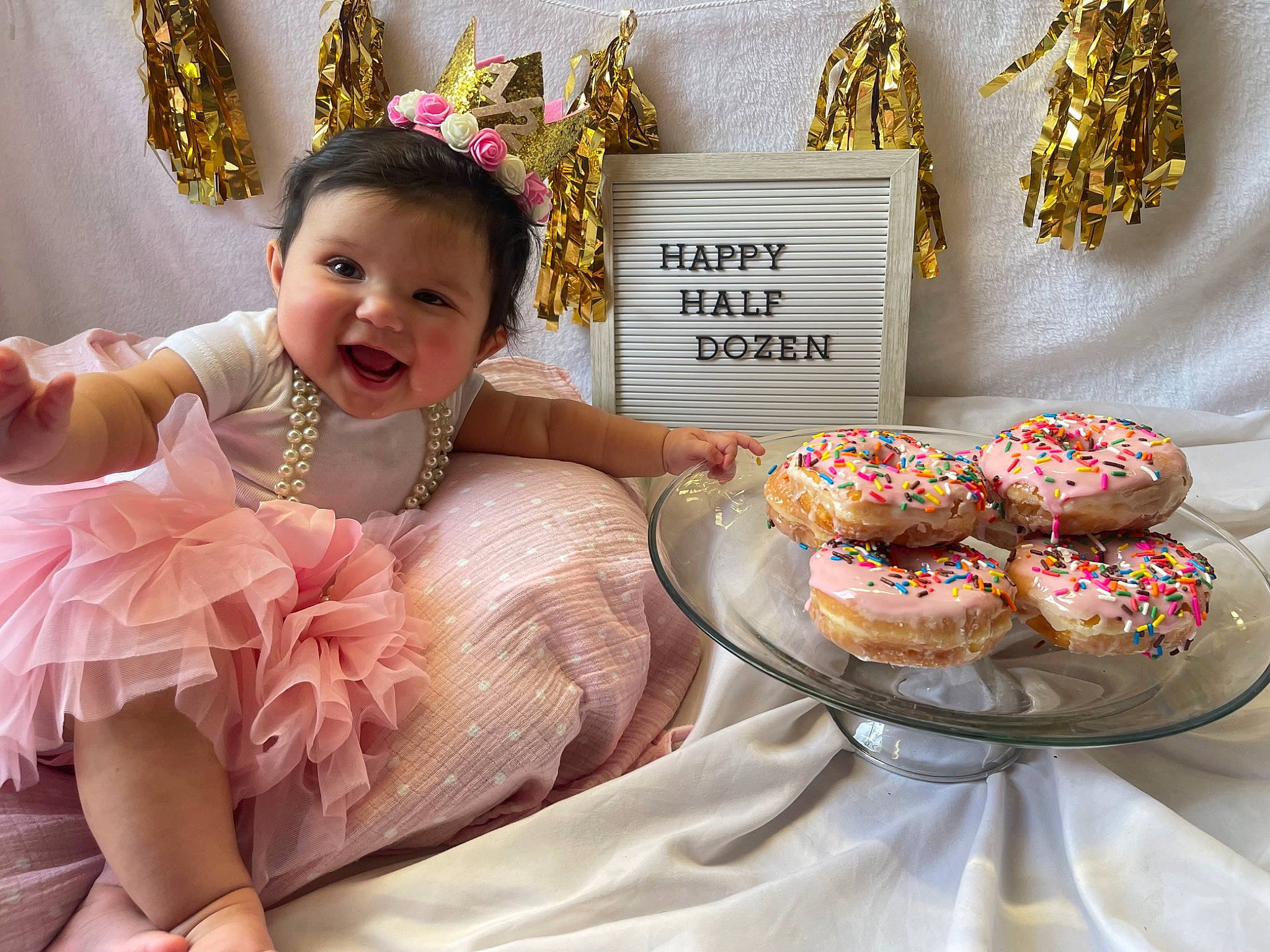 Lily is registered to the contest to win money with this photo: baby_toddler_clothing, baked_goods, cake, cake_decorating, cuisine, dessert, dish, event, food, happy, headpiece, ingredient, jewellery, person, plate, recipe, smile, sugar_cake, sweetness, tableware