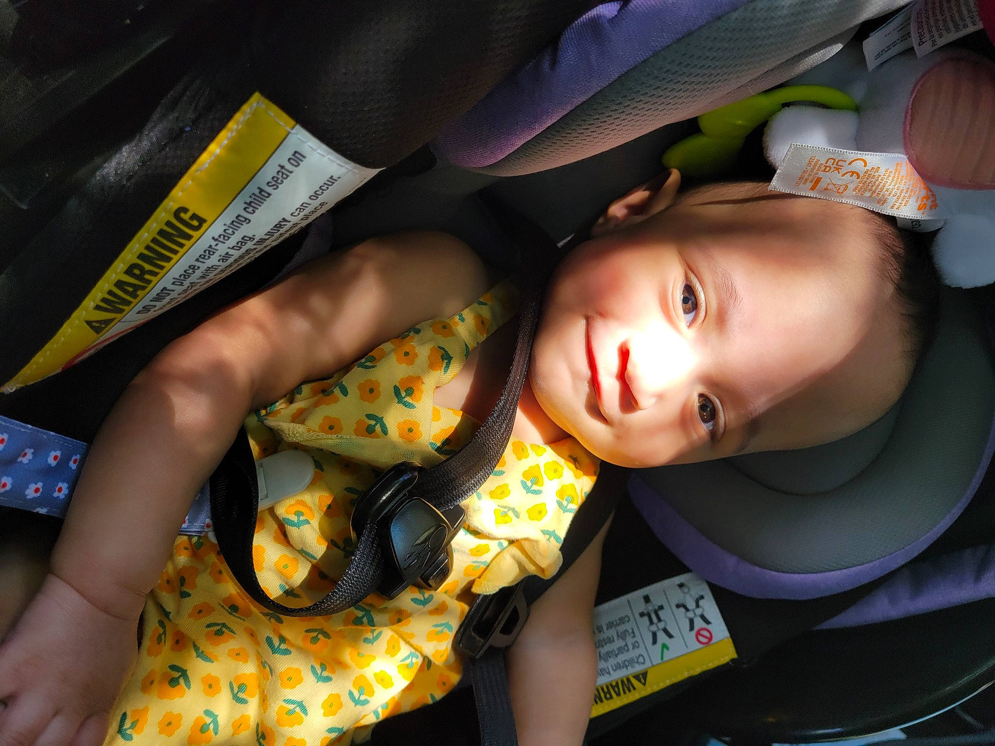 Kaiya is registered to the contest to win money with this photo: baby, baby_products, black_hair, car_seat, cheek, child, fashion_accessory, fun, hairstyle, hat, human_leg, mouth, pattern, person, room, sitting, skin, thigh, toddler
