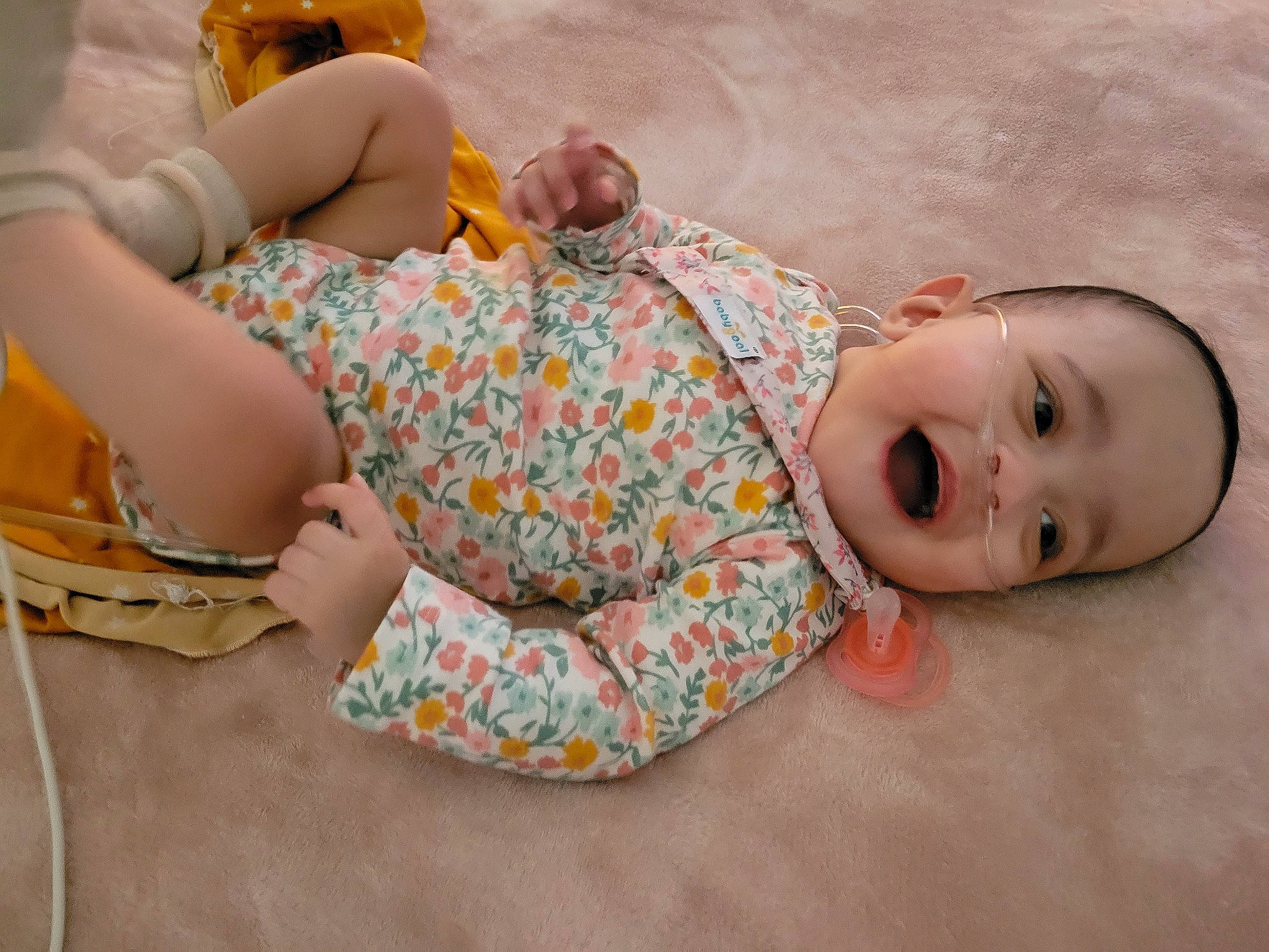 Maiya joined the competition — help win amazing prizes! baby, baby_toddler_clothing, child, comfort, dress, flooring, foot, hand, human_body, human_leg, joint, knee, linens, pattern, person, room, sitting, skin, sleeve, thigh