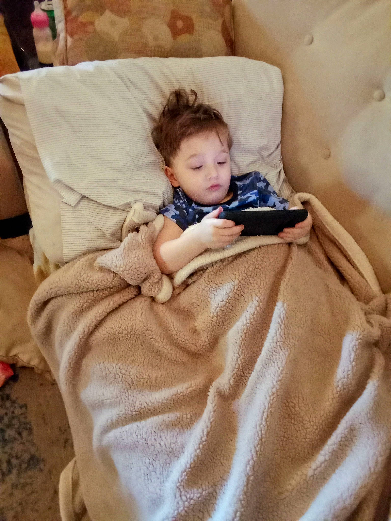 Justin is registered to the contest to win money with this photo: baby, bed_sheet, bedding, bedroom, bedtime, child, comfort, couch, flooring, fur, hardwood, leisure, linens, living_room, person, pillow, room, sitting, throw_pillow, toddler