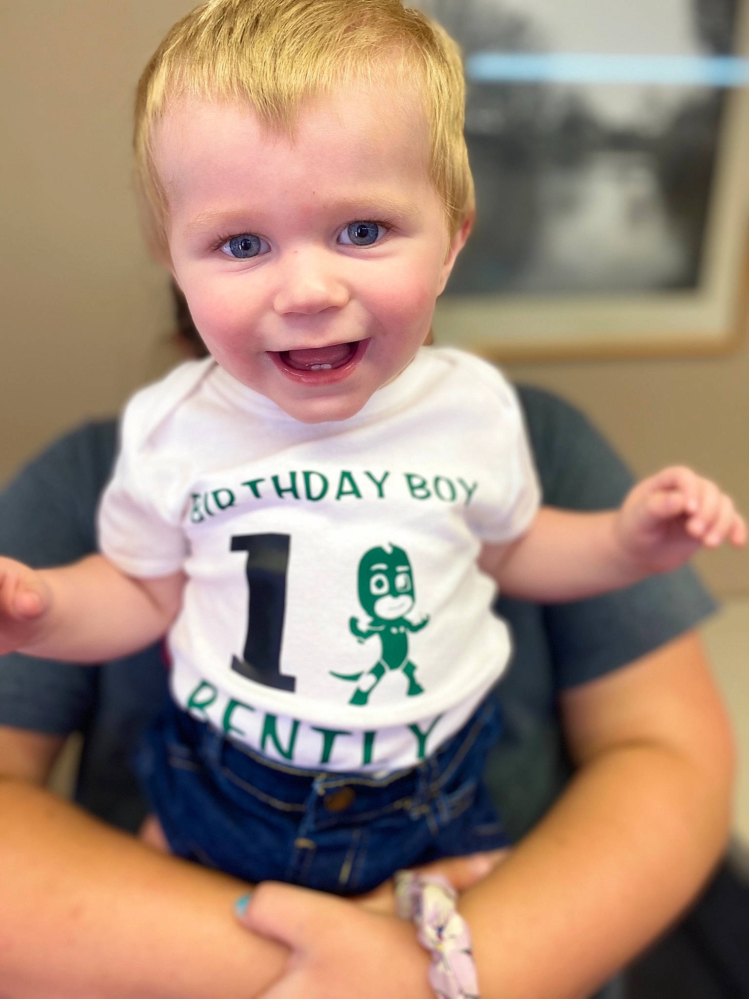 Bently is registered to the contest to win money with this photo: baby, baby_toddler_clothing, cheek, child, face, finger, person, play, product, sitting, skin, sleeve, smile, t_shirt, toddler