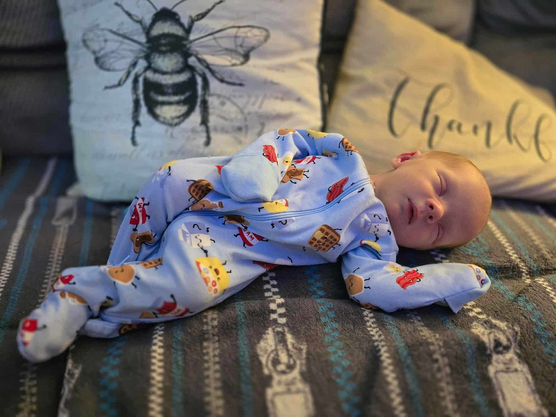 Ayden joined the competition — help win amazing prizes! baby, sleeping, onesie, blanket, pillow, bee_illustration, thankful_text, cozy, patterned, indoor, child, infant, cute, peaceful, soft_lighting, decor, fabric, resting, portrait, home