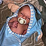 baby, infant, pacifier, blue_towel, hooded_towel, blanket, sleepy, cute, newborn, wrapped, face, skin, hand, lying_down, quilted_surface, soft_texture, indoors, child, baby_clothing, resting
