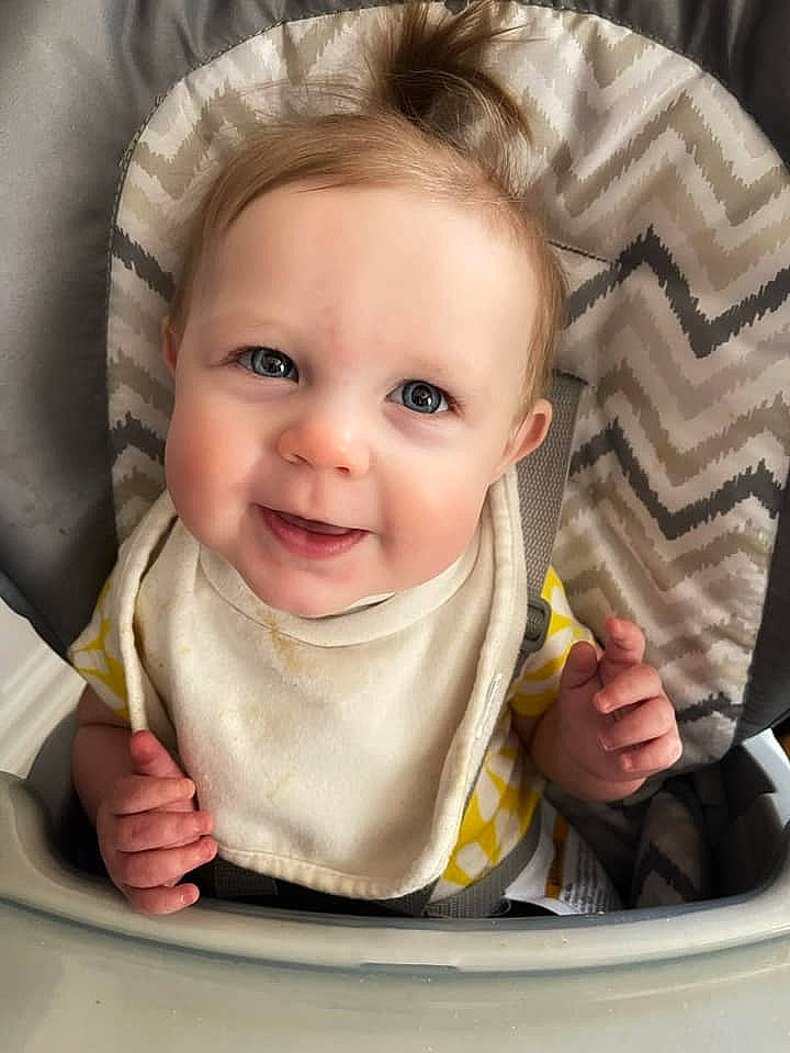 Annabella is registered to the contest to win money with this photo: baby, cheek, chin, eye, eyebrow, facial_expression, hairstyle, hand, human, iris, lip, mouth, nose, organ, outerwear, person, product, skin, sleeve, smile