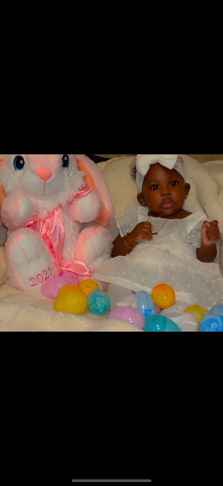 baby, balloon, bed, bodypart, clothing, couch, cream, face, finger, food, furniture, hand, hat, head, newborn, person, photography, portrait, sweets, toy