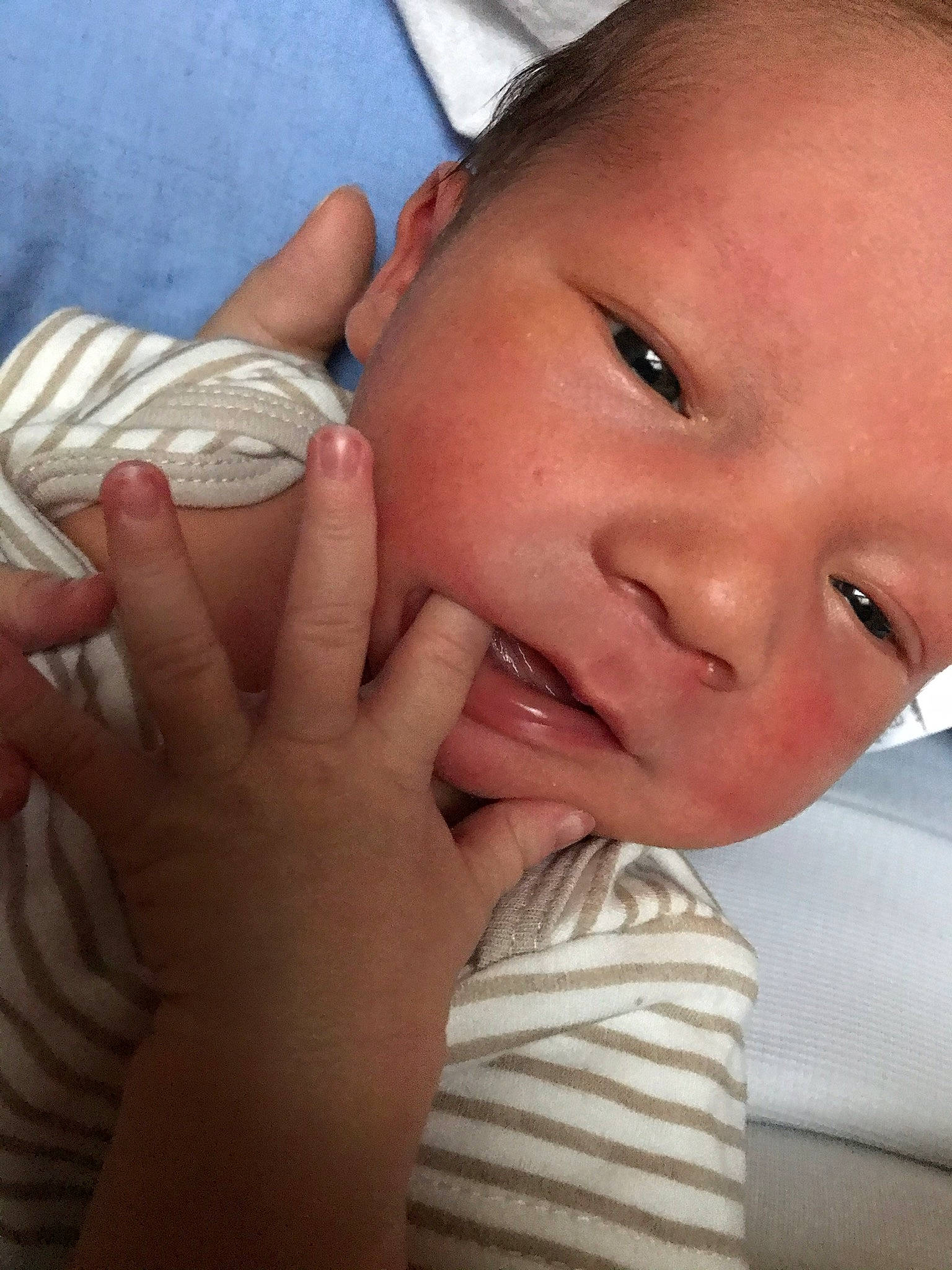 Ezra is registered to the contest to win money with this photo: baby, cheek, child, face, finger, hand, lip, mouth, nail, nose, person, skin, thumb, toddler