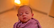 Bailey joined the competition — help win amazing prizes! baby, newborn, sleeping, wrapped, purple_blanket, closeup, indoor, infant, peaceful, soft_lighting, portrait, young_child, cozy, warm_colors, toddler, child, cute, adorable, person, blanket