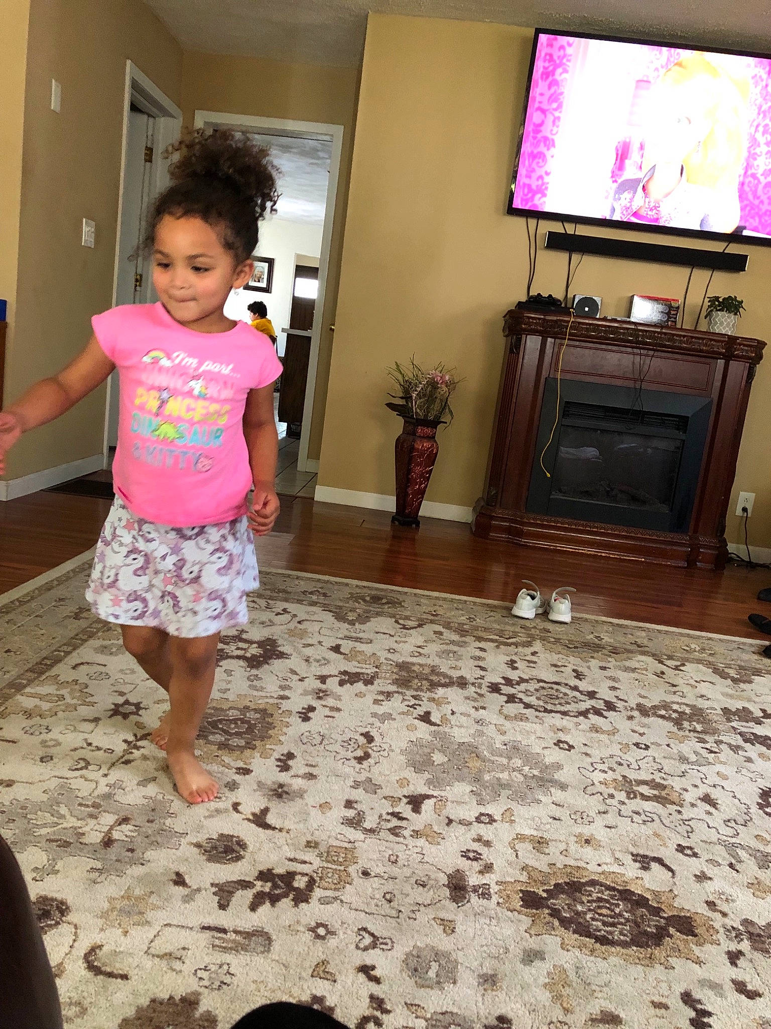 Lia is registered to the contest to win money with this photo: child, electronic_device, floor, flooring, fun, leg, media, person, pink, play, room, technology, television, toddler