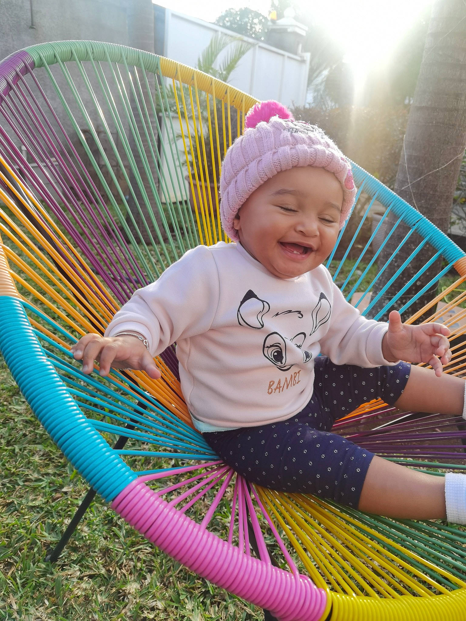 Ashley participe au concours pour gagner de l'argent avec cette photo : baby, baby_toddler_clothing, chair, child, comfort, fun, grass, green, happy, hat, headwear, leaf, leisure, magenta, people, person, pink, plant, recreation, sitting