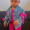 toddler, child, denim_jacket, pink_outfit, headband, bow, socks, sofa, indoor, person, fashion, cute, portrait, standing, young_child, clothing, casual, serious_expression, home, baby