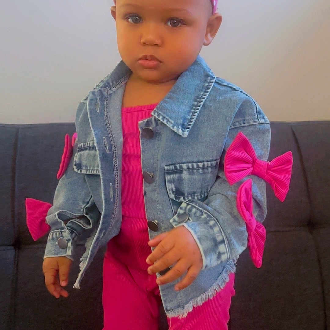 Nikylah is registered to the contest to win money with this photo: toddler, child, denim_jacket, pink_outfit, headband, bow, socks, sofa, indoor, person, fashion, cute, portrait, standing, young_child, clothing, casual, serious_expression, home, baby