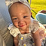 baby, child, smile, headband, bow, dress, flower_pattern, daisy, crawling, car_seat, sunlight, outdoor, grass, person, cute, infant, happy, portrait, young_child, clothing