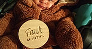 Treasure joined the competition — help win amazing prizes! baby, infant, costume, bear_suit, plush, wooden_plaque, four_months, cute, smiling, child, face, hood, soft, warm, indoors, blanket, car_seat, portrait, young, happy