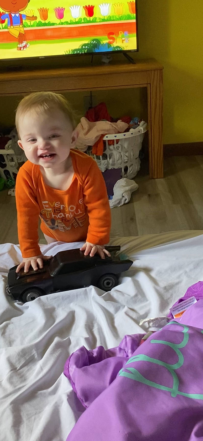 Christian is registered to the contest to win money with this photo: baby, baby_toddler_clothing, chair, child, comfort, event, flooring, fun, happy, lap, linens, magenta, pattern, person, play, room, sitting, sleeve, smile, t_shirt