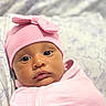 baby, infant, pink_hat, pink_clothing, swaddled, face, eyes, cute, newborn, portrait, closeup, soft_light, indoor, blanket, headwear, adorable, child, skin, expression, sleepwear