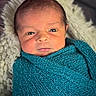 baby, blanket, child, closeup, cozy, cute, expression, face, indoors, infant, knit, newborn, person, portrait, resting, soft, teal, texture, wrapped, young