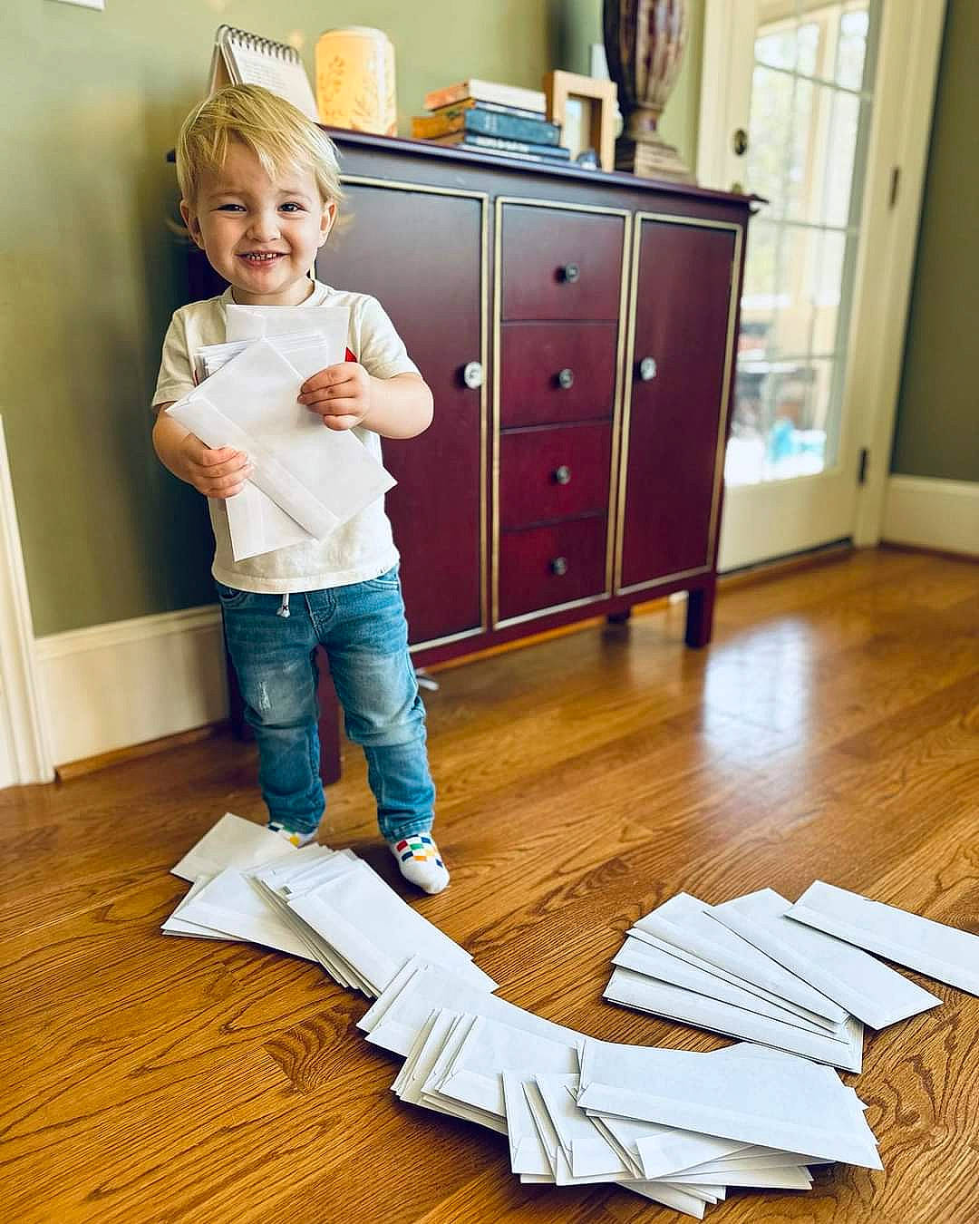 Koda is registered to the contest to win money with this photo: baby_toddler_clothing, cabinetry, chest_of_drawers, child, comfort, cupboard, drawer, dresser, floor, flooring, hardwood, jeans, joy, laminate_flooring, leg, person, smile, toddler, varnish, wood