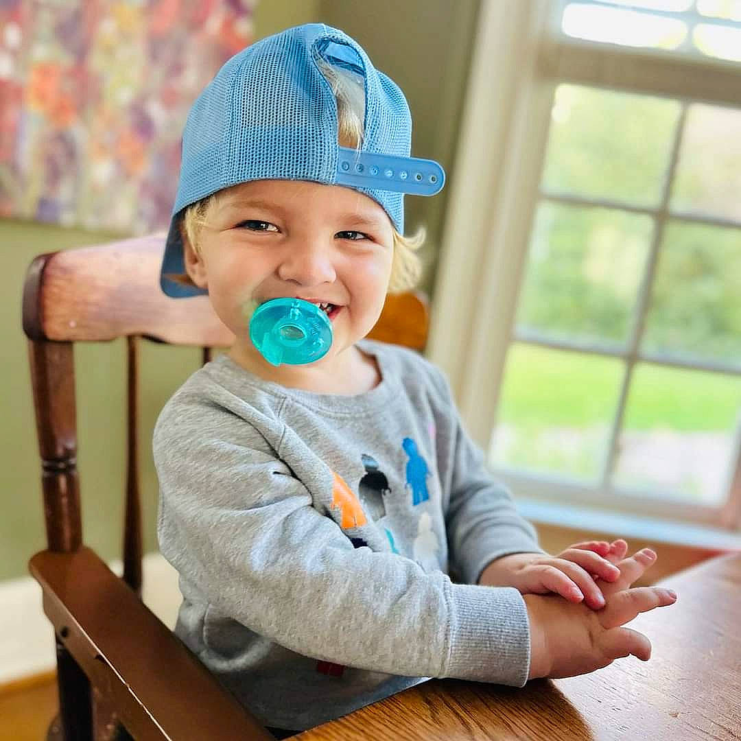 Koda joined the competition — help win amazing prizes! arm, baby, baby_toddler_clothing, cap, cheek, child, clothing, comfort, electric_blue, face, finger, fun, hand, happy, headwear, joy, person, sitting, skin, sleeve
