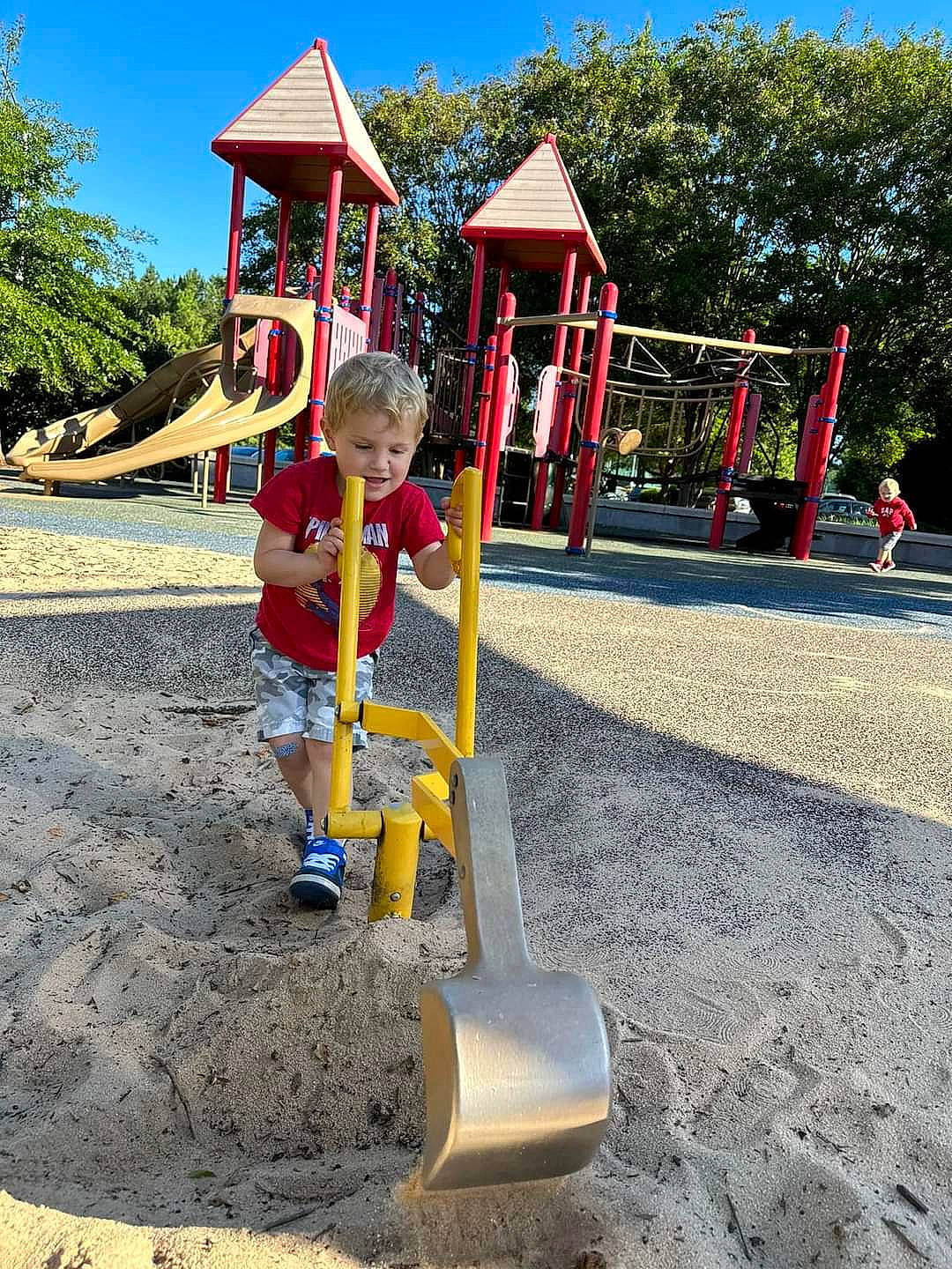 Kayden is registered to the contest to win money with this photo: asphalt, child, chute, city, concrete, fun, joy, leisure, outdoor_play_equipment, person, plant, play, playground, playground_slide, recreation, shorts, sky, smile, soil, toddler