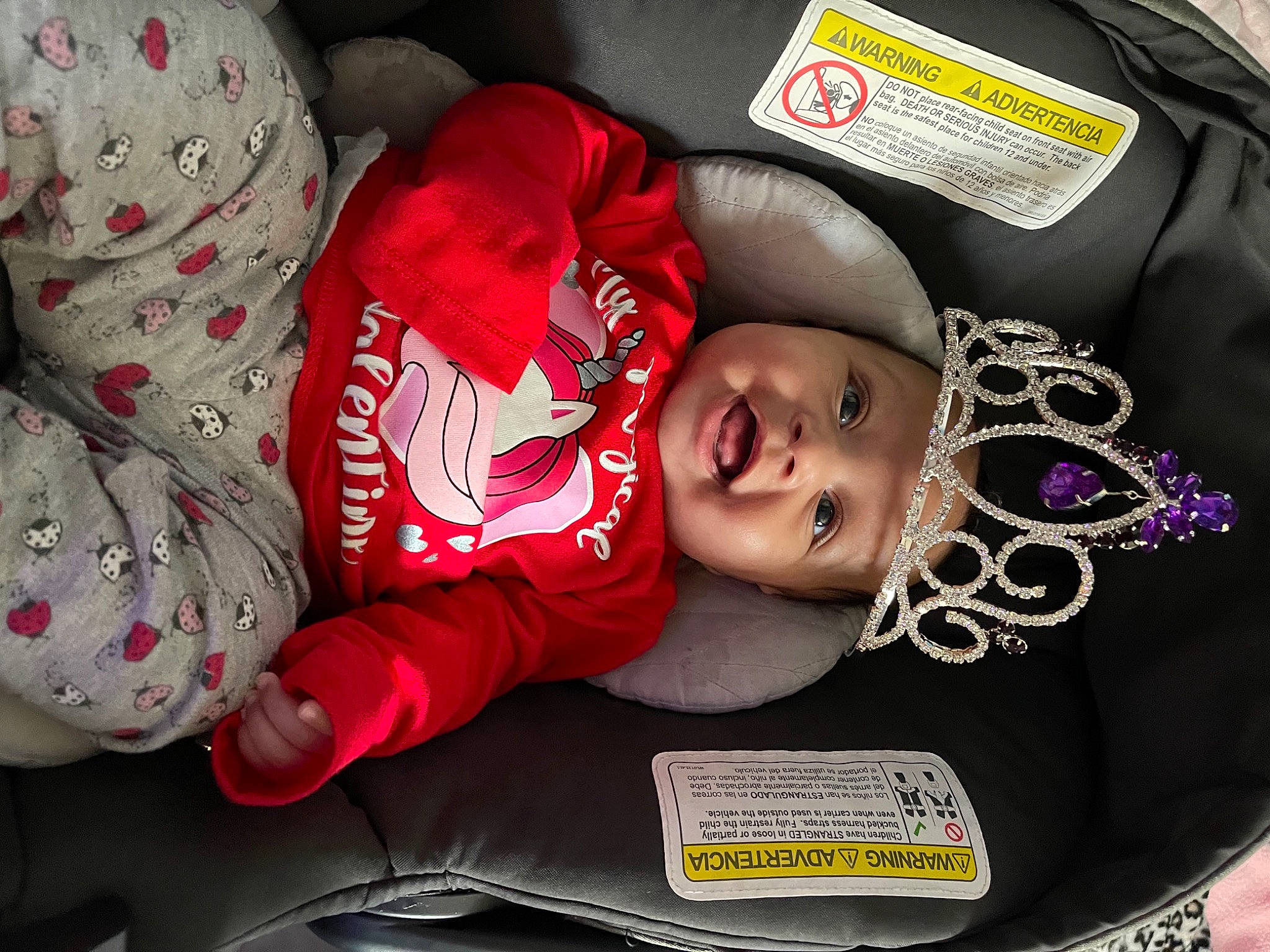 London is registered to the contest to win money with this photo: baby, baby_carriage, baby_products, baby_toddler_clothing, car_seat, carmine, child, comfort, event, eye, facial_expression, happy, headgear, headwear, human_body, mammal, person, sleeve, smile, toddler