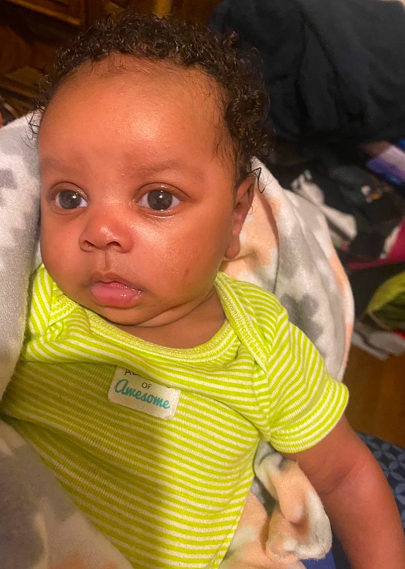 Journi is registered to the contest to win money with this photo: baby_toddler_clothing, cheek, chin, ear, eye, eyebrow, eyelash, finger, gesture, hair, hand, happy, iris, lip, mouth, neck, nose, person, skin, sleeve