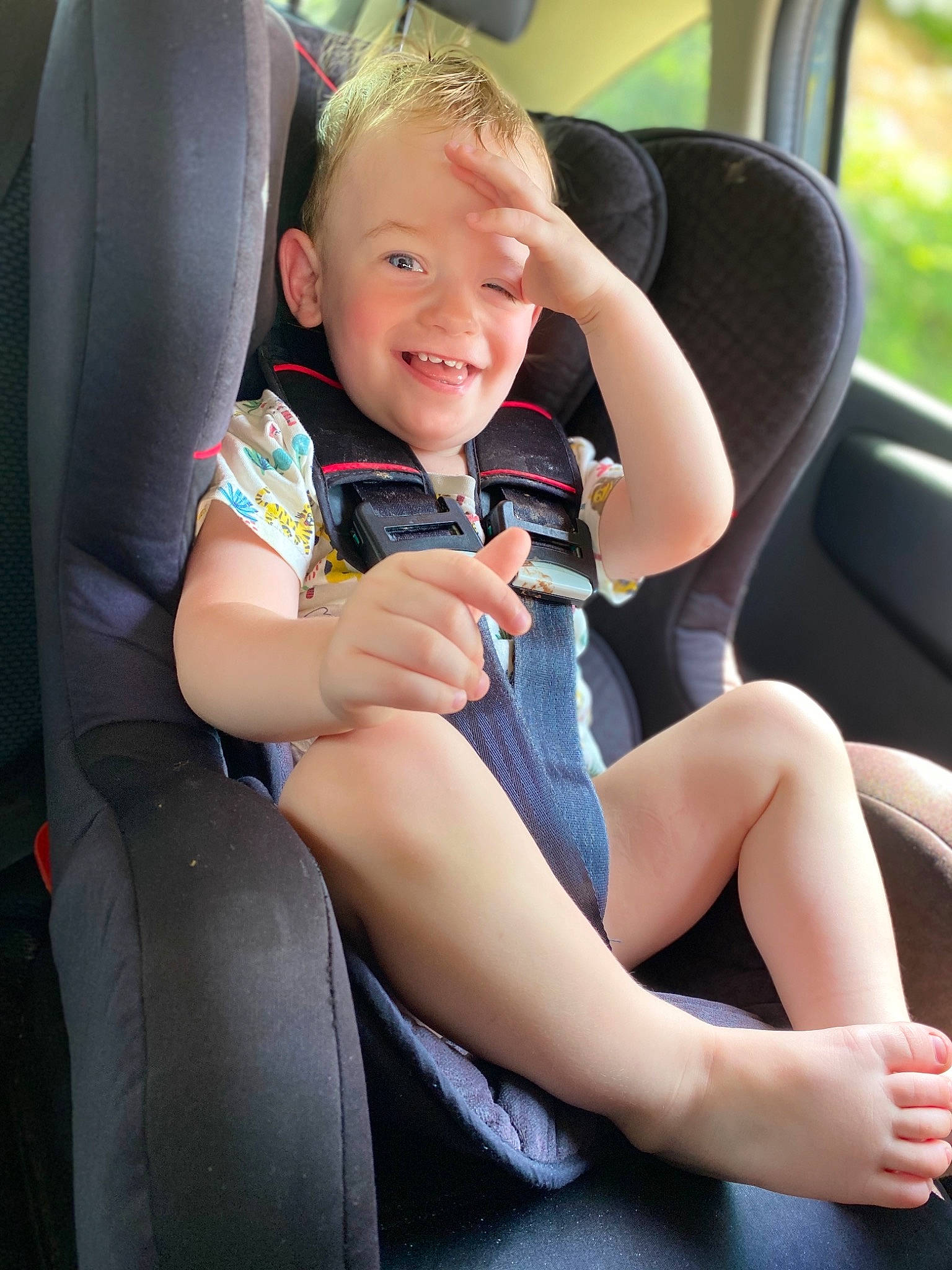 Leo is registered to the contest to win money with this photo: auto_part, baby_in_car_seat, car, car_seat, car_seat_cover, child, family_car, joy, leg, person, seat_belt, sitting, toddler, vacation