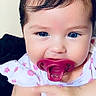 baby, child, pacifier, blue_eyes, pigtails, hair_ties, cute, infant, holding_hand, floral_clothing, closeup, portrait, adorable, skin, face, smiling, indoors, person, young_child, toddler